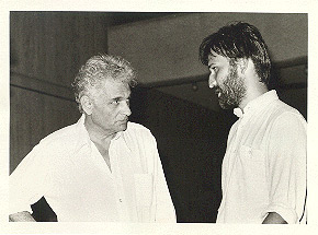 Black and white photo of two people in white shirts looking at each other