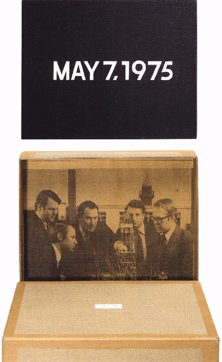 Frame with MAY 7,1975 and another of newspaper on a box